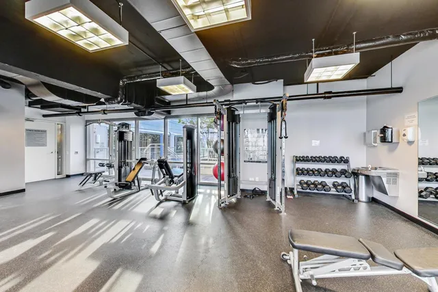 a living room with furniture a chandelier and a flat screen tv