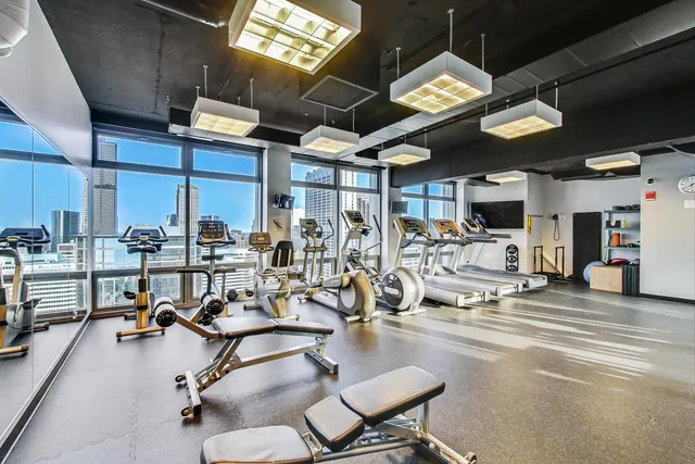 a living room with furniture a projector and a flat screen tv