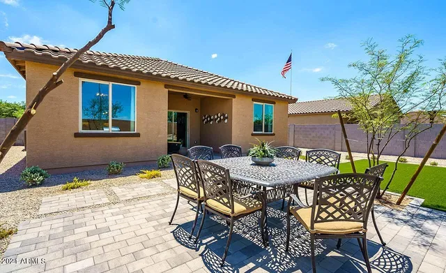 a view of a house with backyard and sitting area