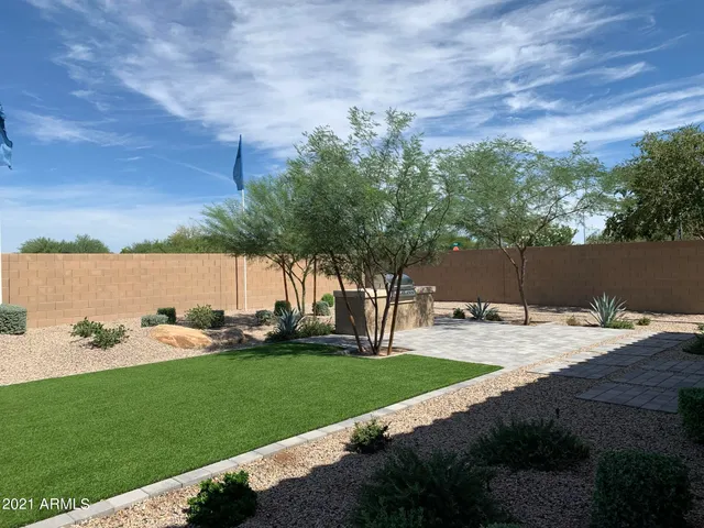 a view of a backyard with sitting area
