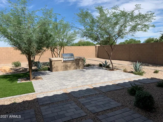 a backyard of a house with a yard and outdoor seating