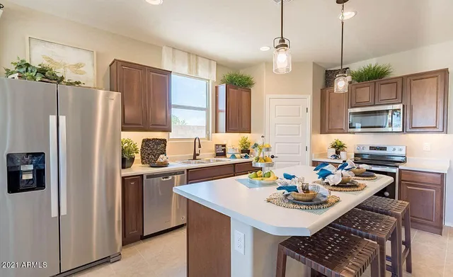 a kitchen with sink refrigerator and cabinets
