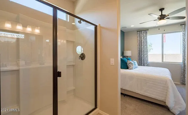 a en suite bathroom with a shower and a sink