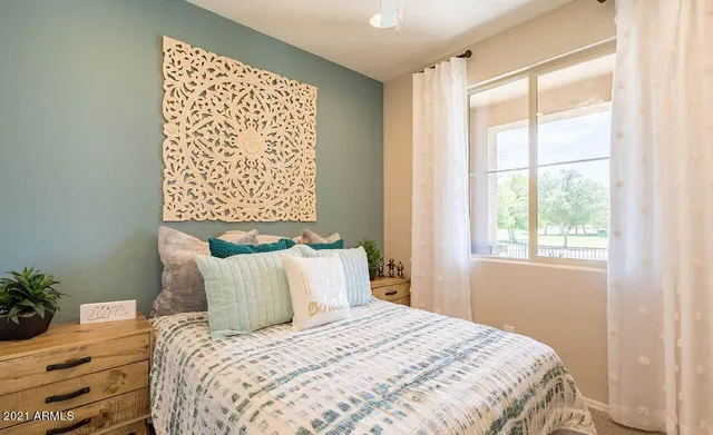 a bedroom with a bed and a window