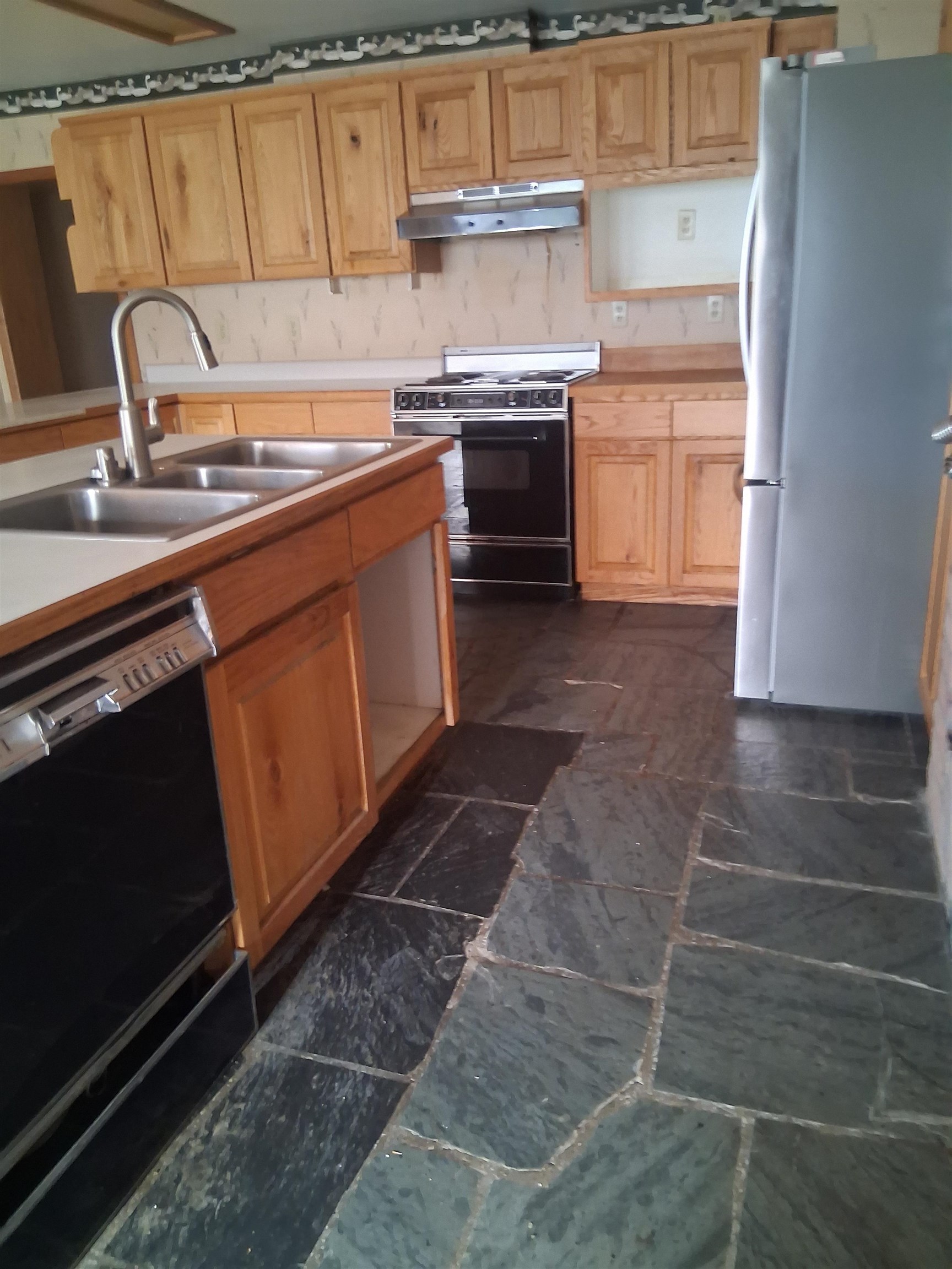 1983 River Road Fruita, CO 81521 - Photo 26 of 31 a kitchen with stainless steel appliances a sink stove and cabinets