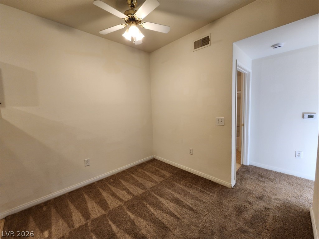 231 West Horizon Ridge Parkway, Unit 417 Henderson, NV 89012 - Photo 11 of 39 Empty room with dark carpet and ceiling fan