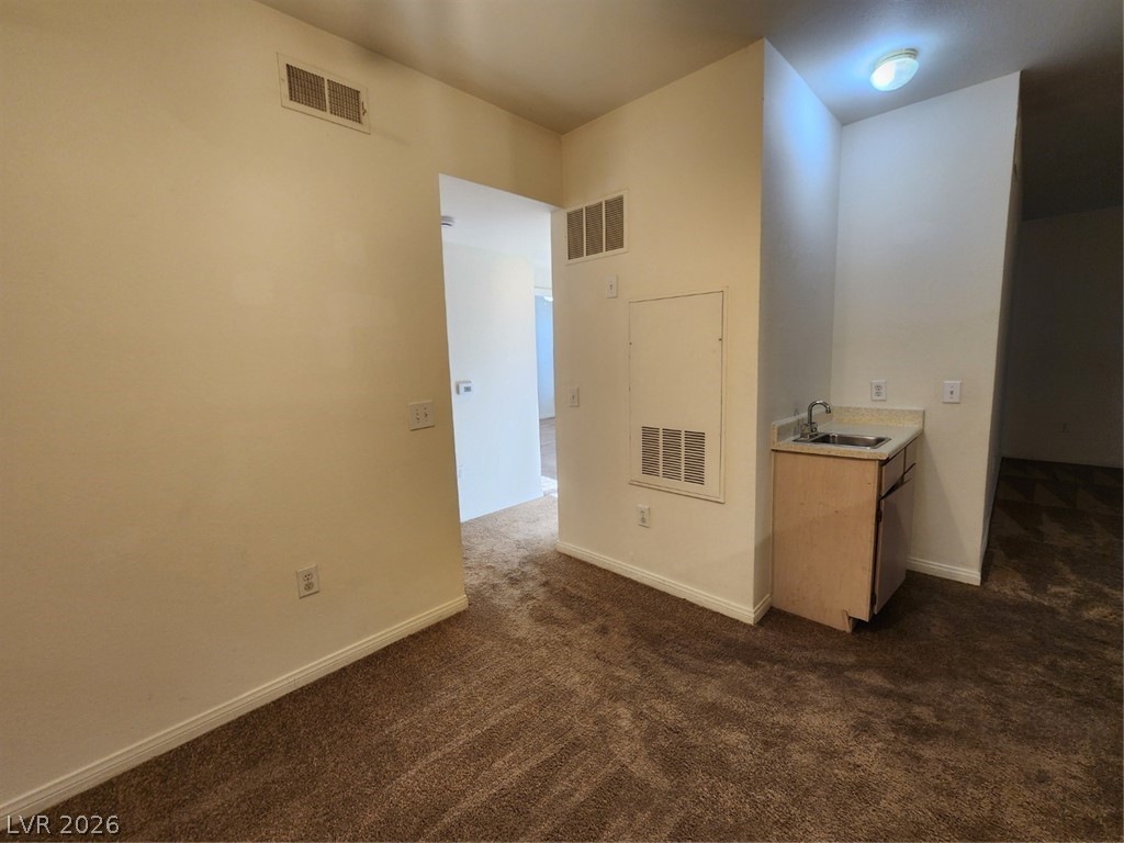 231 West Horizon Ridge Parkway, Unit 417 Henderson, NV 89012 - Photo 12 of 39 Unfurnished room featuring dark carpet and baseboards