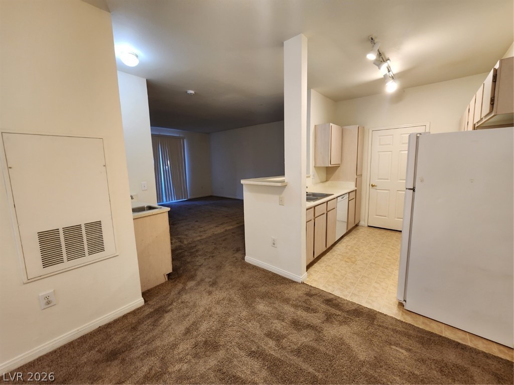 231 West Horizon Ridge Parkway, Unit 417 Henderson, NV 89012 - Photo 39 of 39 Kitchen with refrigerator, light countertops, light carpet, a heating unit, and open floor plan