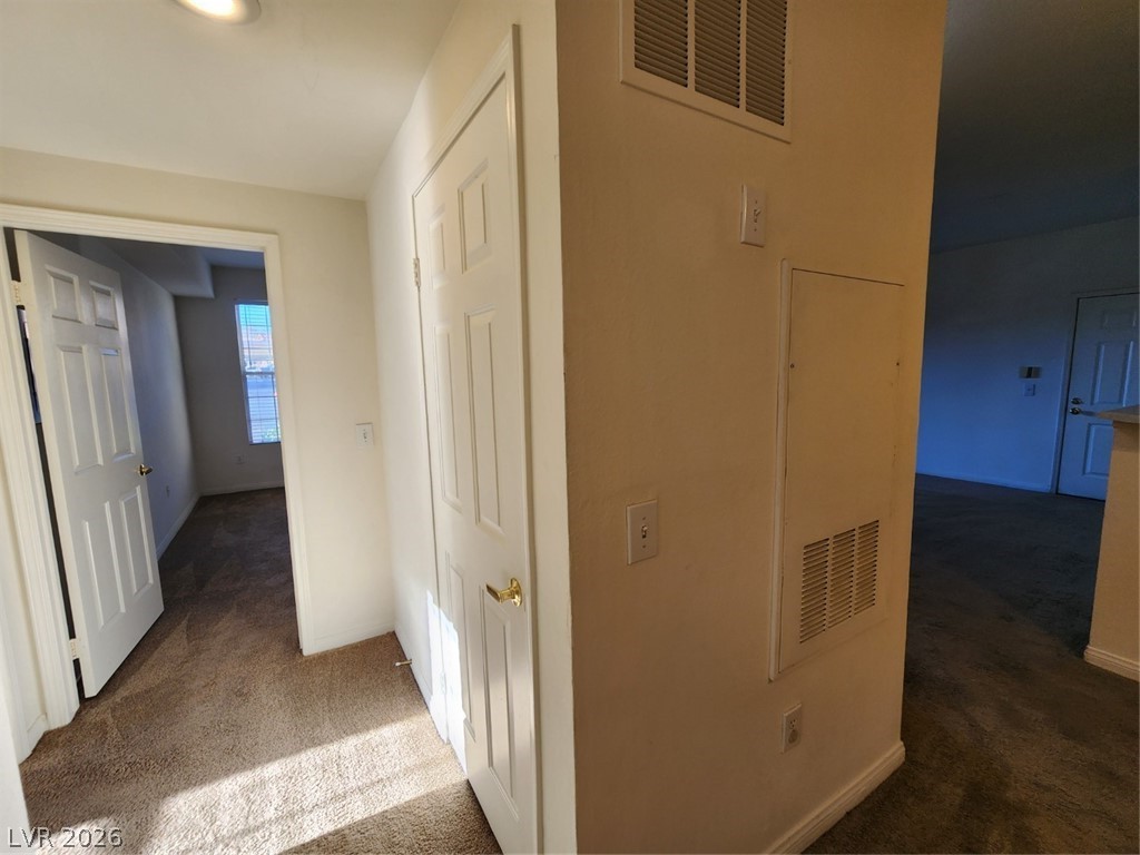 231 West Horizon Ridge Parkway, Unit 417 Henderson, NV 89012 - Photo 20 of 39 Corridor featuring dark carpet and baseboards