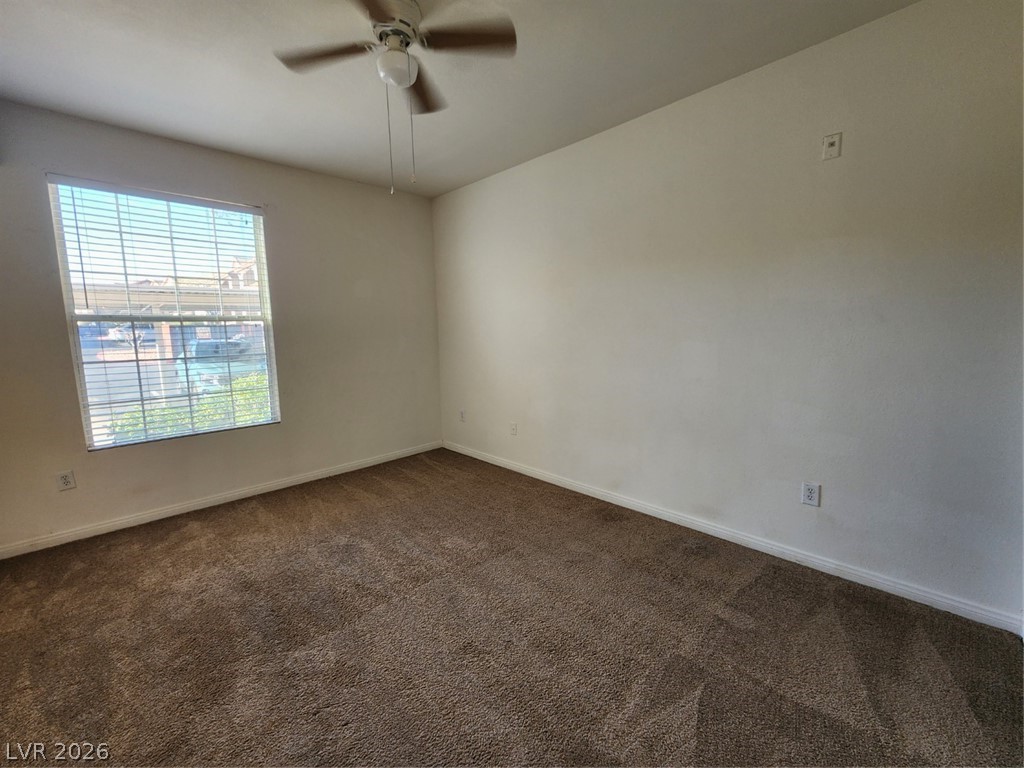 231 West Horizon Ridge Parkway, Unit 417 Henderson, NV 89012 - Photo 22 of 39 Empty room featuring dark carpet and ceiling fan