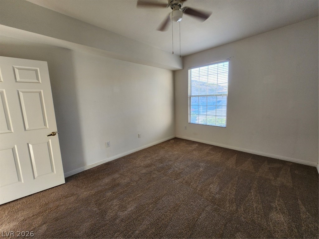 231 West Horizon Ridge Parkway, Unit 417 Henderson, NV 89012 - Photo 25 of 39 Unfurnished room featuring dark colored carpet and a ceiling fan