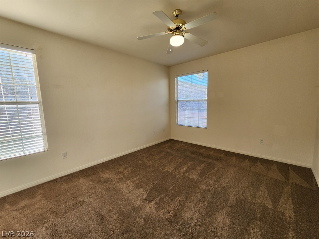 231 West Horizon Ridge Parkway, Unit 417 Henderson, NV 89012 - Photo 26 of 39 Spare room featuring dark colored carpet and ceiling fan