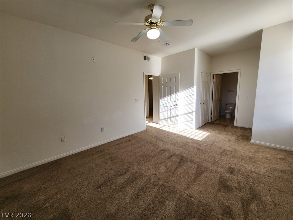 231 West Horizon Ridge Parkway, Unit 417 Henderson, NV 89012 - Photo 28 of 39 Unfurnished bedroom with dark carpet, a closet, and ceiling fan