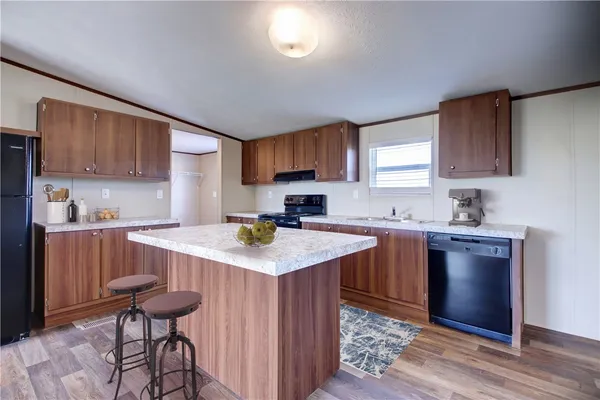 a living room with dining table and wooden floor