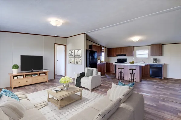 a kitchen with a sink cabinets and wooden floor