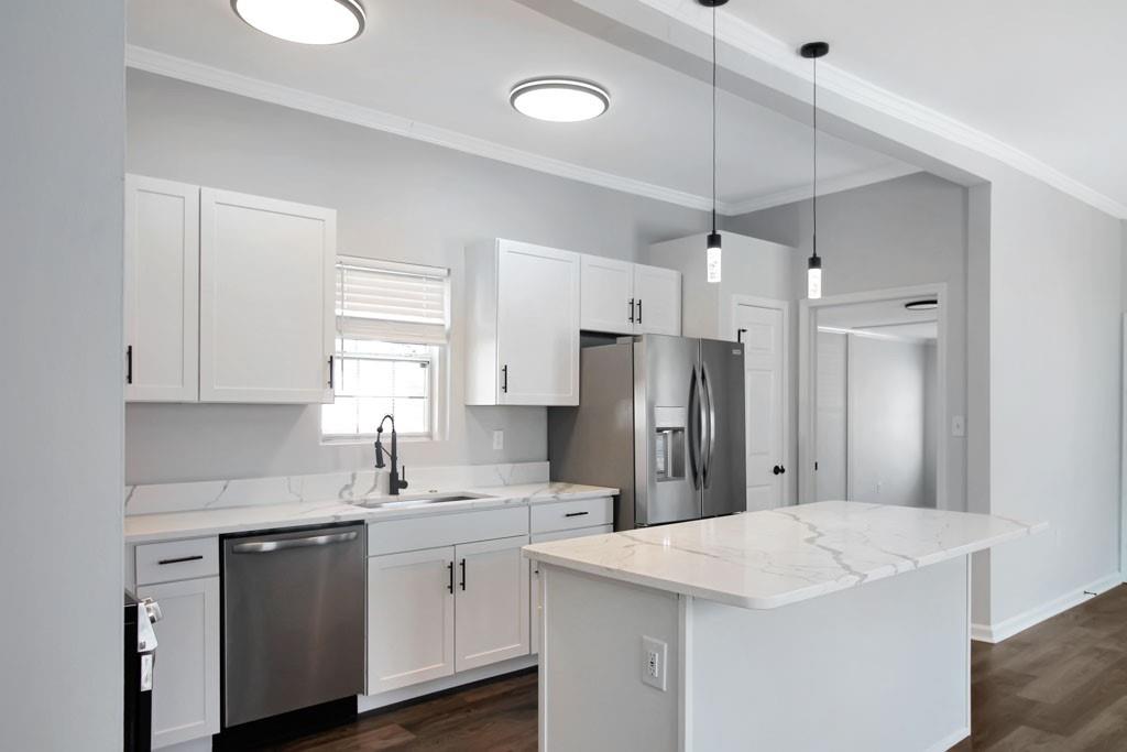 3087 Semmes Street Atlanta, GA 30344 - Photo 5 of 18 a kitchen with kitchen island white cabinets and white appliances