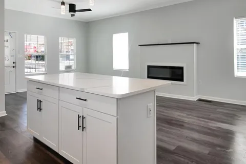 a kitchen with a sink and a mirror