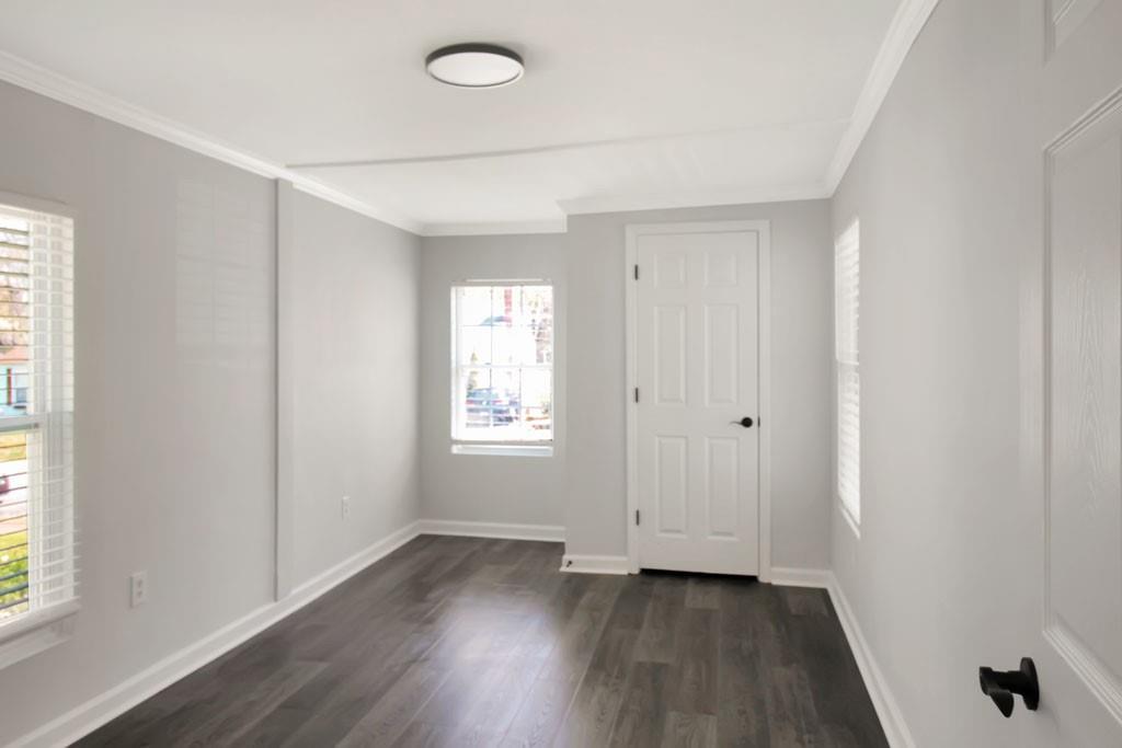3087 Semmes Street Atlanta, GA 30344 - Photo 8 of 18 an empty room with wooden floor and windows