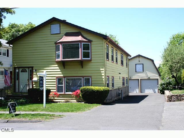 250 Ruane Street Fairfield, CT 06824 - Photo 1 of 1 a front view of a house with a yard and garage