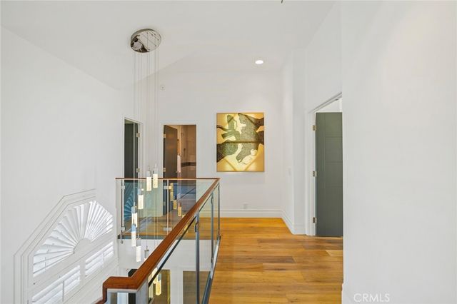 a view of a hallway with furniture and wooden floor