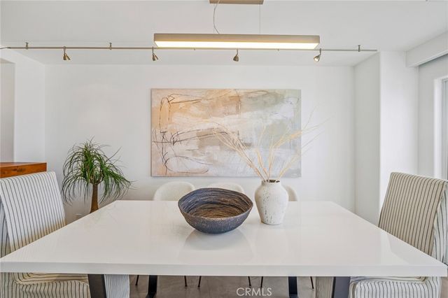 a bedroom with a bed and a potted plant