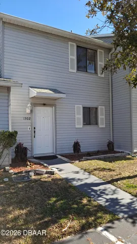 a view of a house with swimming pool and sitting area