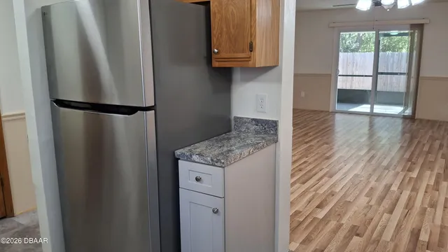 a view of a street with a house on the road