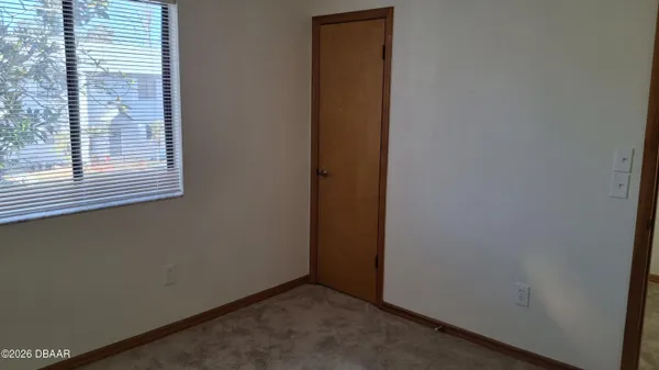 a view of a hallway with a door