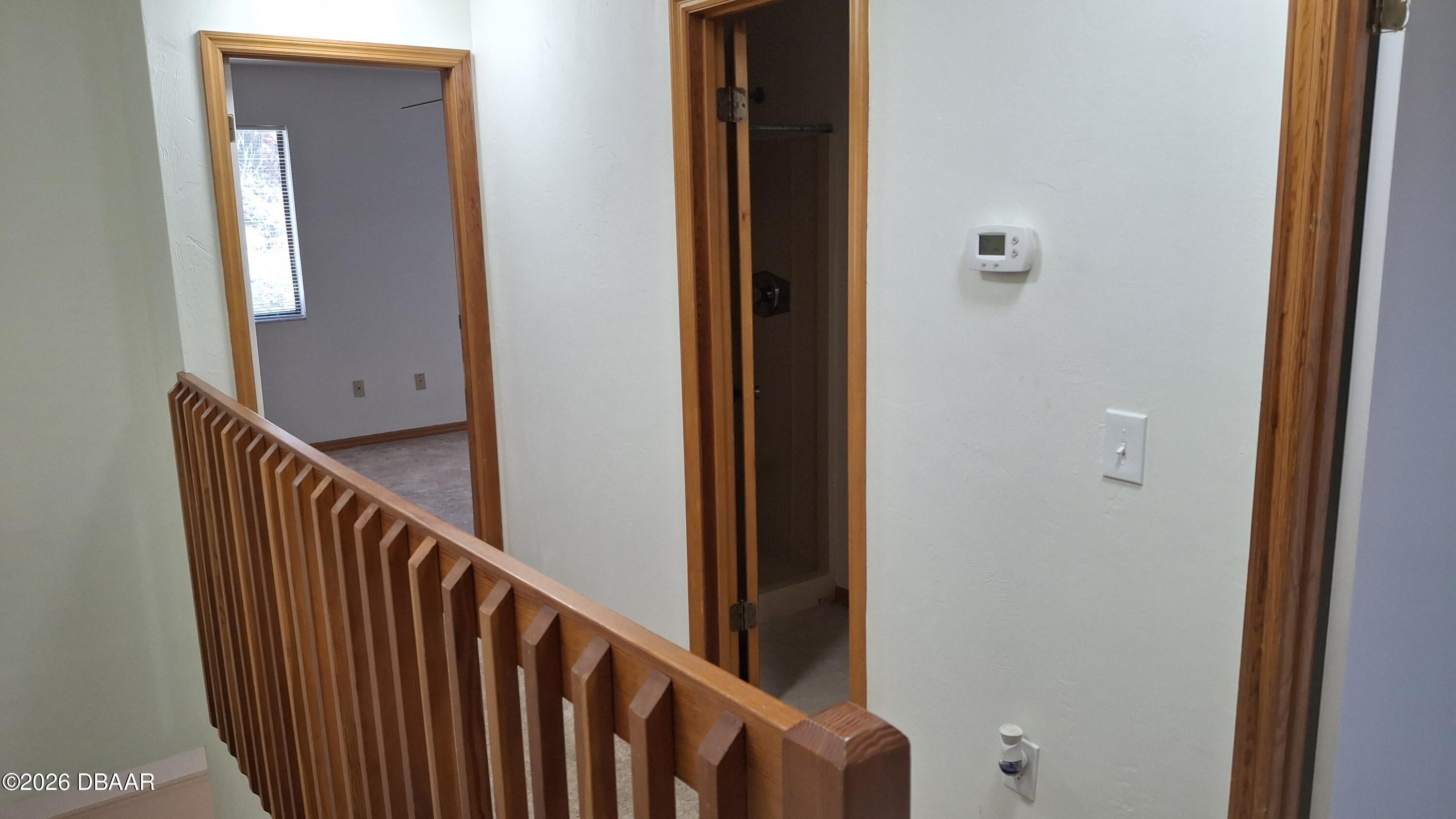 1302 Deer Springs Road Port Orange, FL 32129 - Photo 28 of 43 a view of a hallway with wooden floor and staircase
