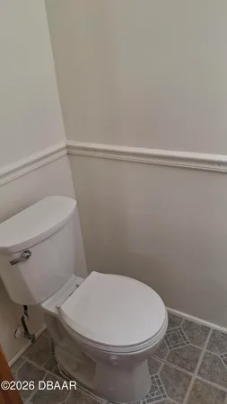 a white toilet sitting next to a shower