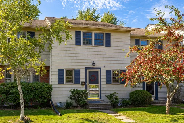 a front view of a house with yard and garage