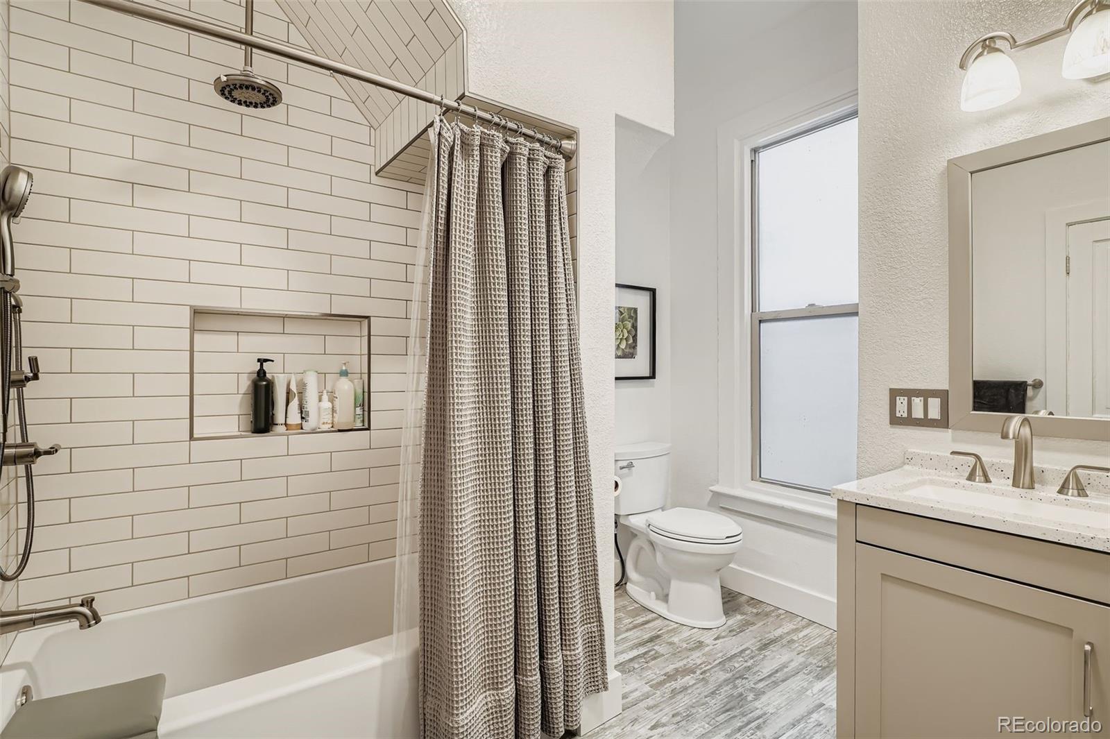 3531 Quitman Street Denver, CO 80212 - Photo 14 of 26 a bathroom with a toilet and a shower