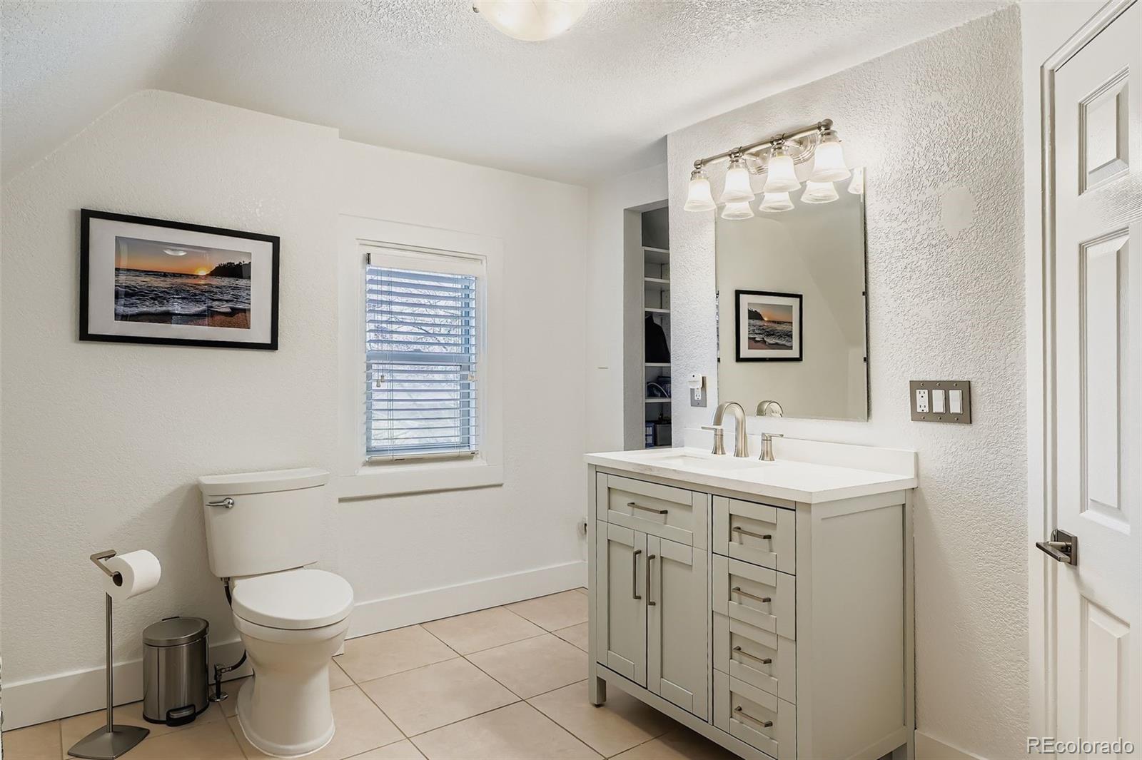 3531 Quitman Street Denver, CO 80212 - Photo 18 of 26 a bathroom with a toilet a sink and mirror