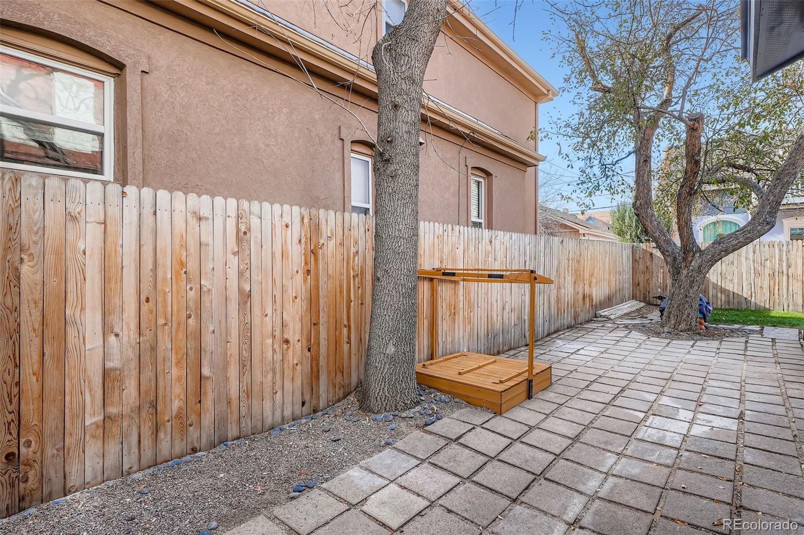 3531 Quitman Street Denver, CO 80212 - Photo 20 of 26 a view of a backyard with a chair and wooden fence