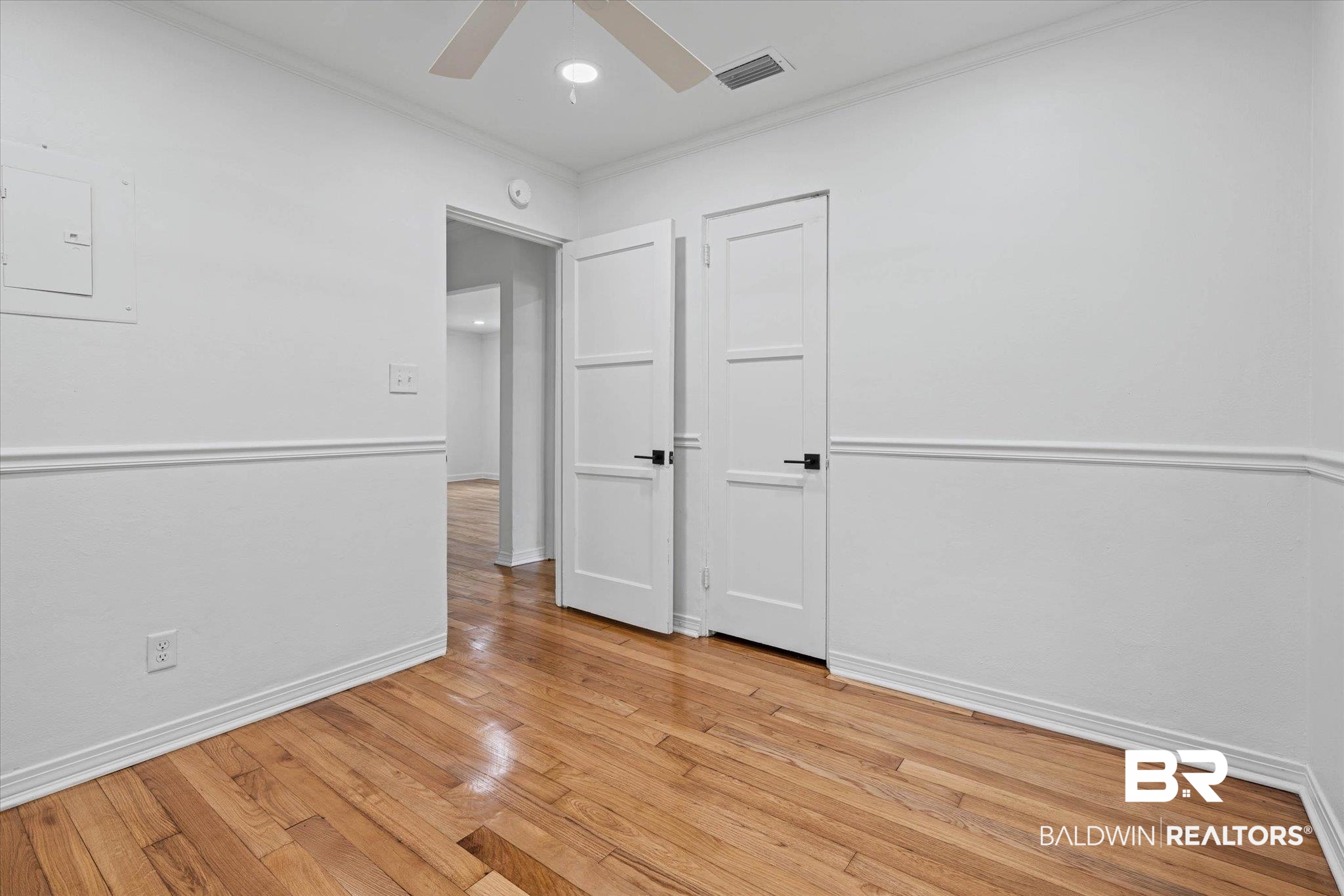 41 Hathaway Road West Mobile, AL 36608 - Photo 16 of 24 Empty room with ornamental molding, light wood finished floors, ceiling fan, electric panel, and recessed lighting