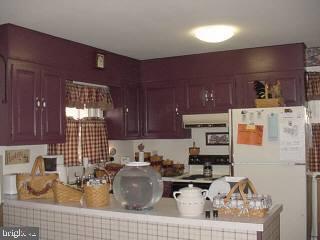 33364 Bob Smith Road Delmar, MD 21875 - Photo 3 of 6 a kitchen with a refrigerator and a stove top oven