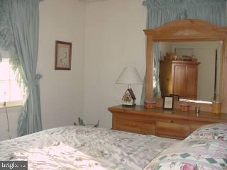 33364 Bob Smith Road Delmar, MD 21875 - Photo 5 of 6 a bedroom with a bed and a dresser
