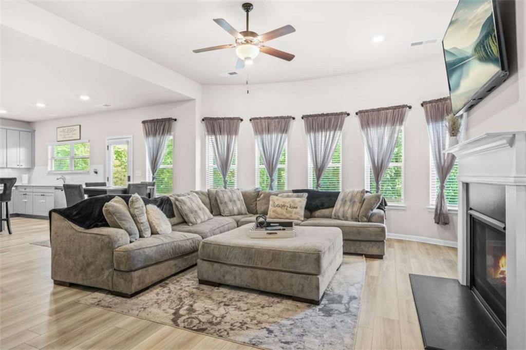 361 Traditions Lane Hampton, GA 30228 - Photo 13 of 35 a living room with furniture fireplace and a large window