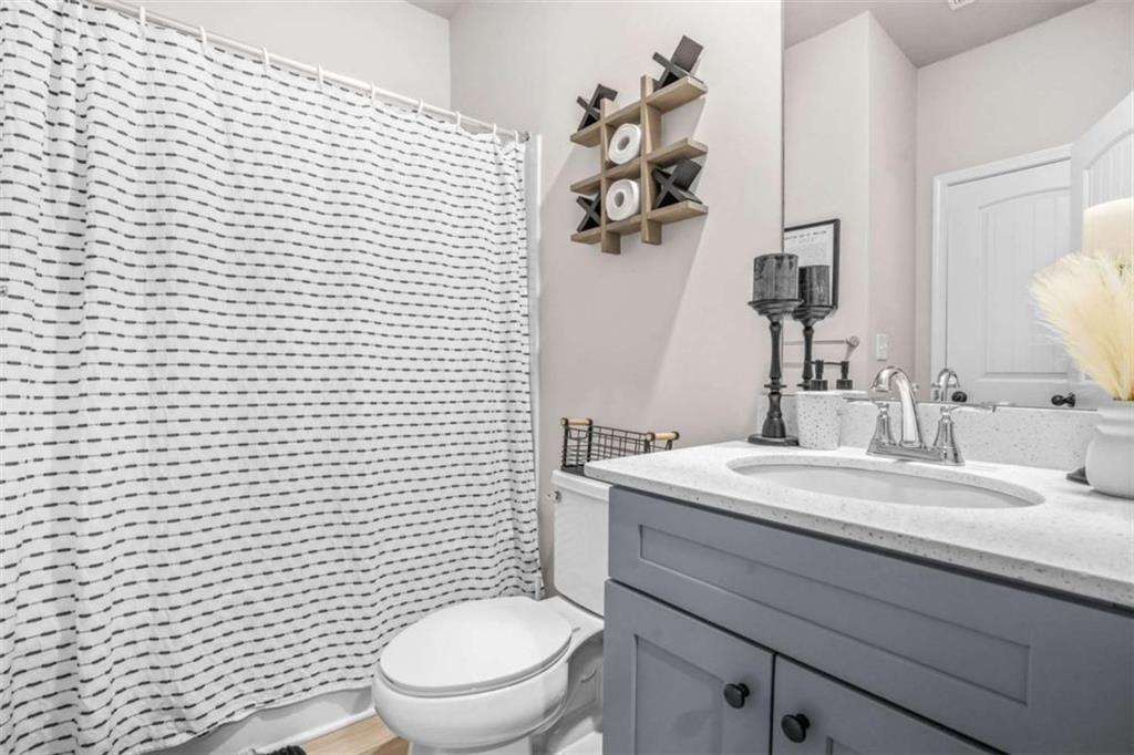 361 Traditions Lane Hampton, GA 30228 - Photo 18 of 35 a bathroom with a toilet sink vanity and mirror