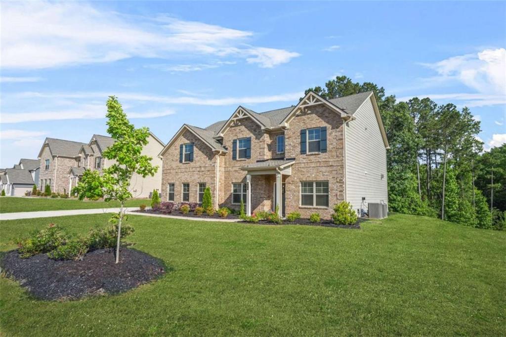 361 Traditions Lane Hampton, GA 30228 - Photo 2 of 35 a front view of a house with a garden