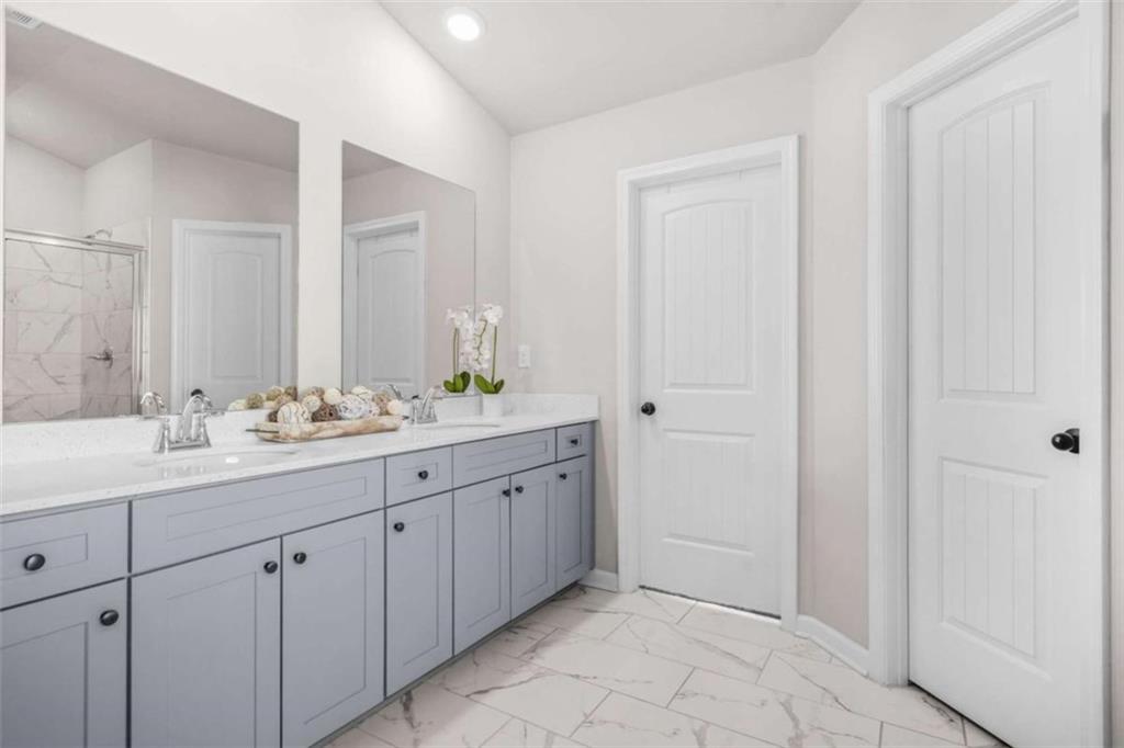 361 Traditions Lane Hampton, GA 30228 - Photo 22 of 35 a bathroom with a granite countertop sink and a mirror