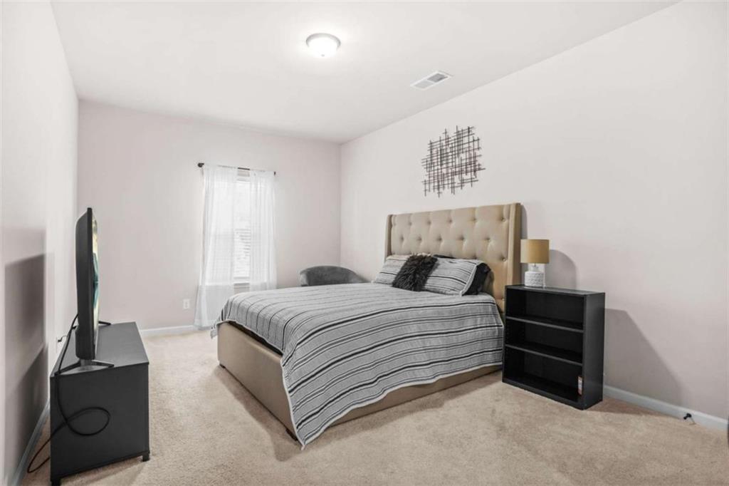 361 Traditions Lane Hampton, GA 30228 - Photo 25 of 35 a bedroom with a bed and a television