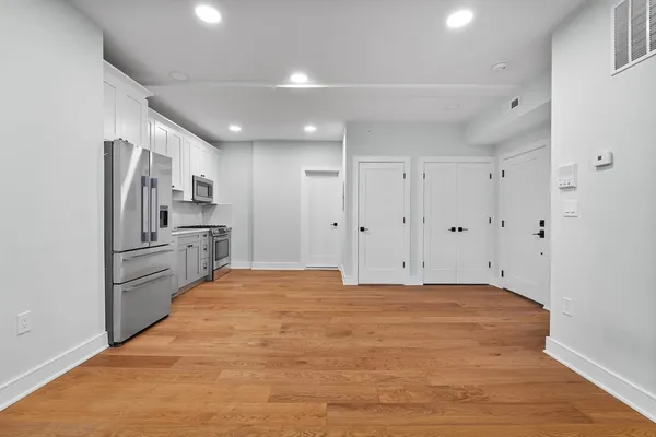 a large kitchen with cabinets and stainless steel appliances