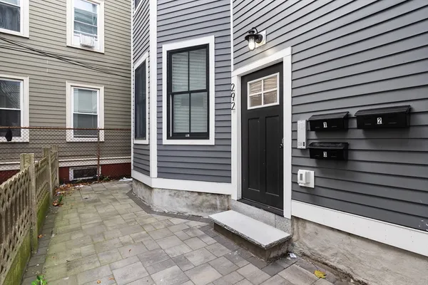 a view of a house with a door and a fire pit