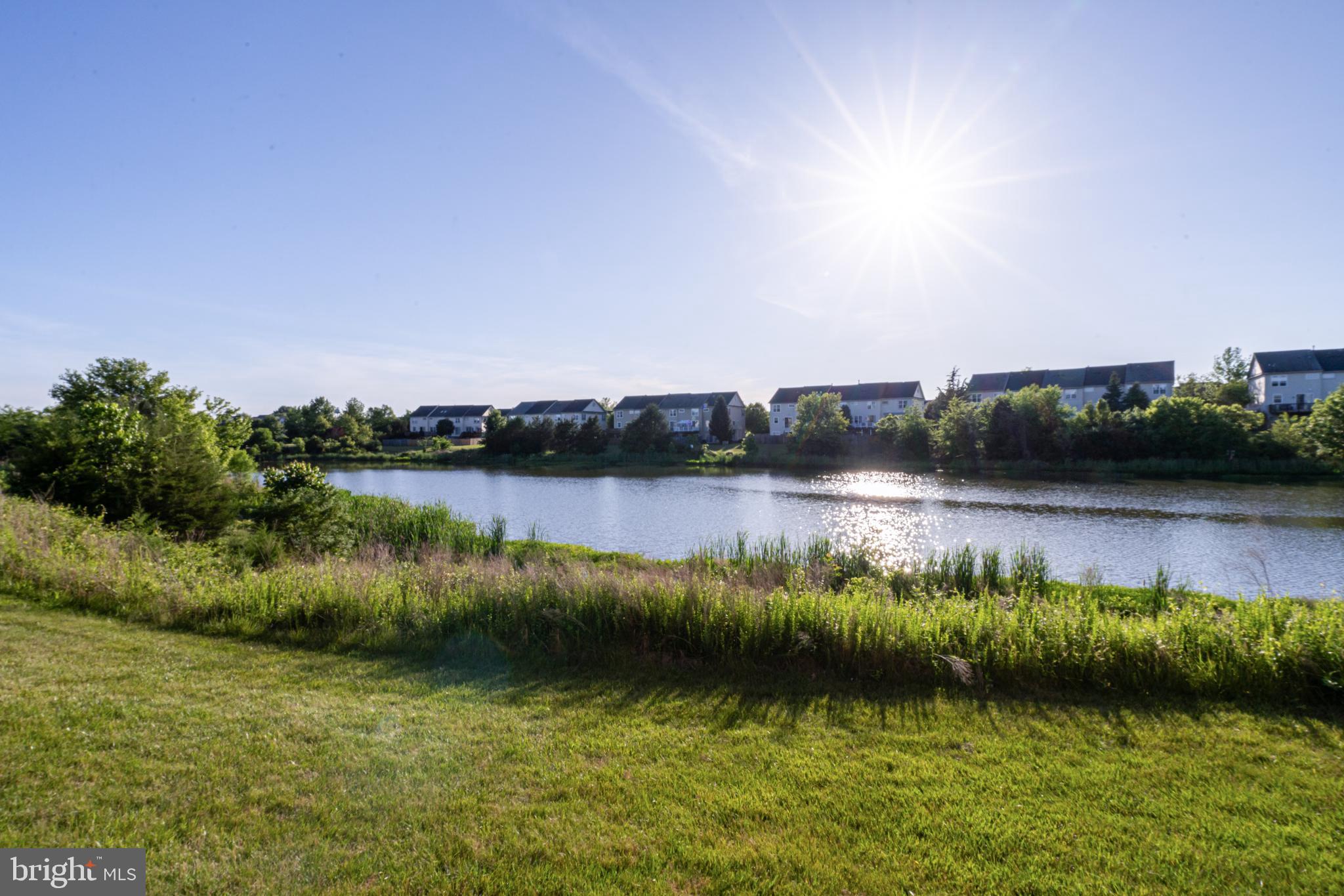 9231 Ribbon Falls Loop Bristow, VA 20136 - Photo 37 of 40 a view of a lake with houses in the back