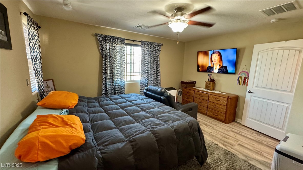 2293 Chandler Ranch Place Laughlin, NV 89029 - Photo 17 of 23 Bedroom featuring light wood-style floors and a ceiling fan