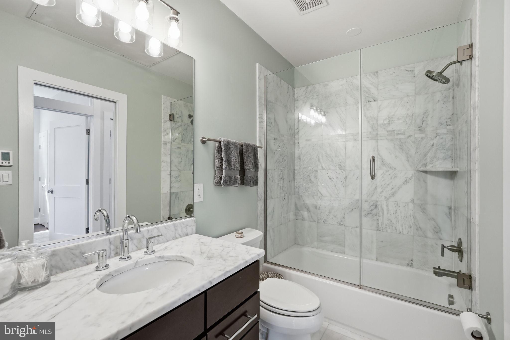 1700 Euclid Street Northwest, Unit B3 Washington, DC 20009 - Photo 12 of 17 a bathroom with a granite countertop sink toilet and shower