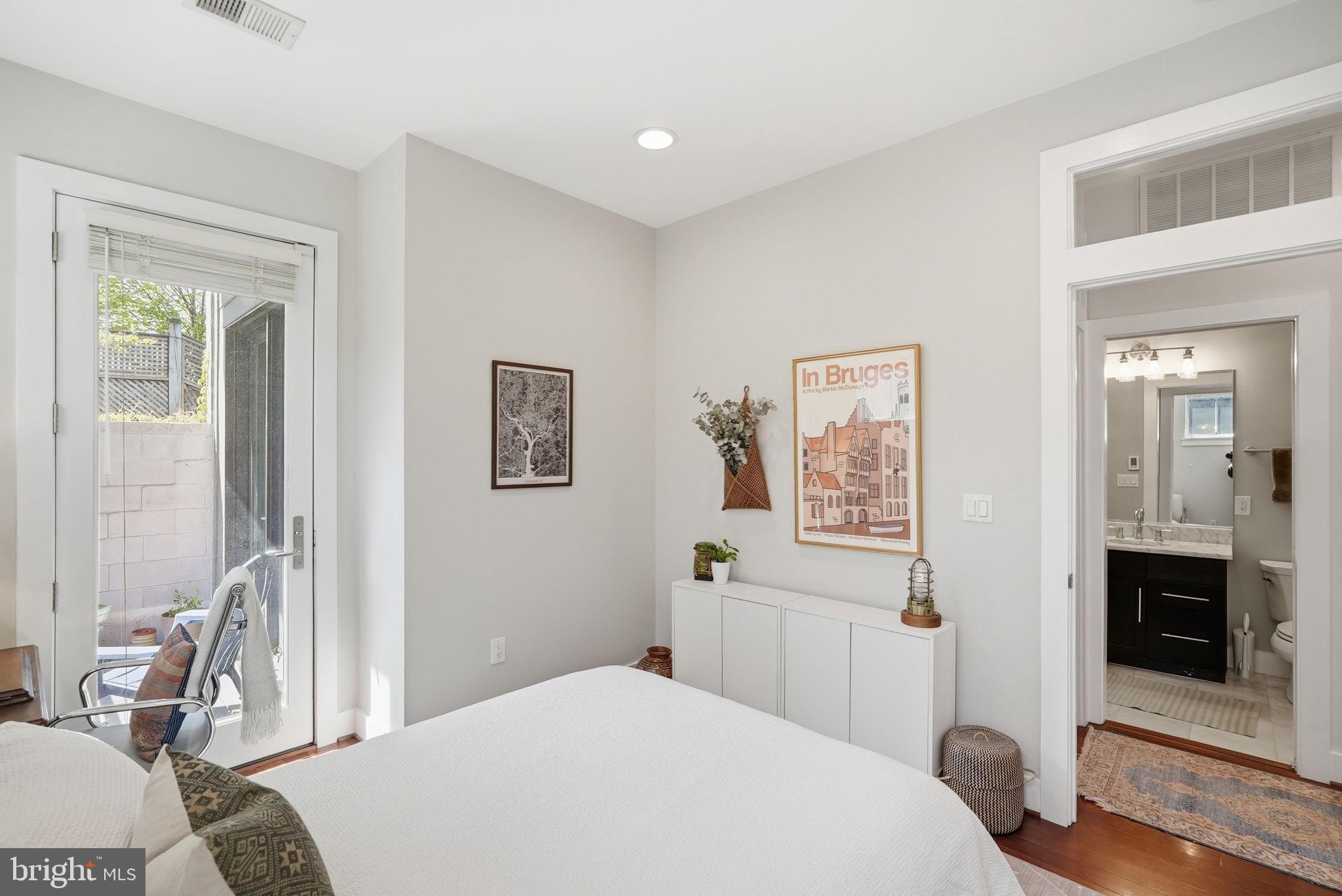1700 Euclid Street Northwest, Unit B3 Washington, DC 20009 - Photo 14 of 17 a bedroom with a bed and a view of kitchen