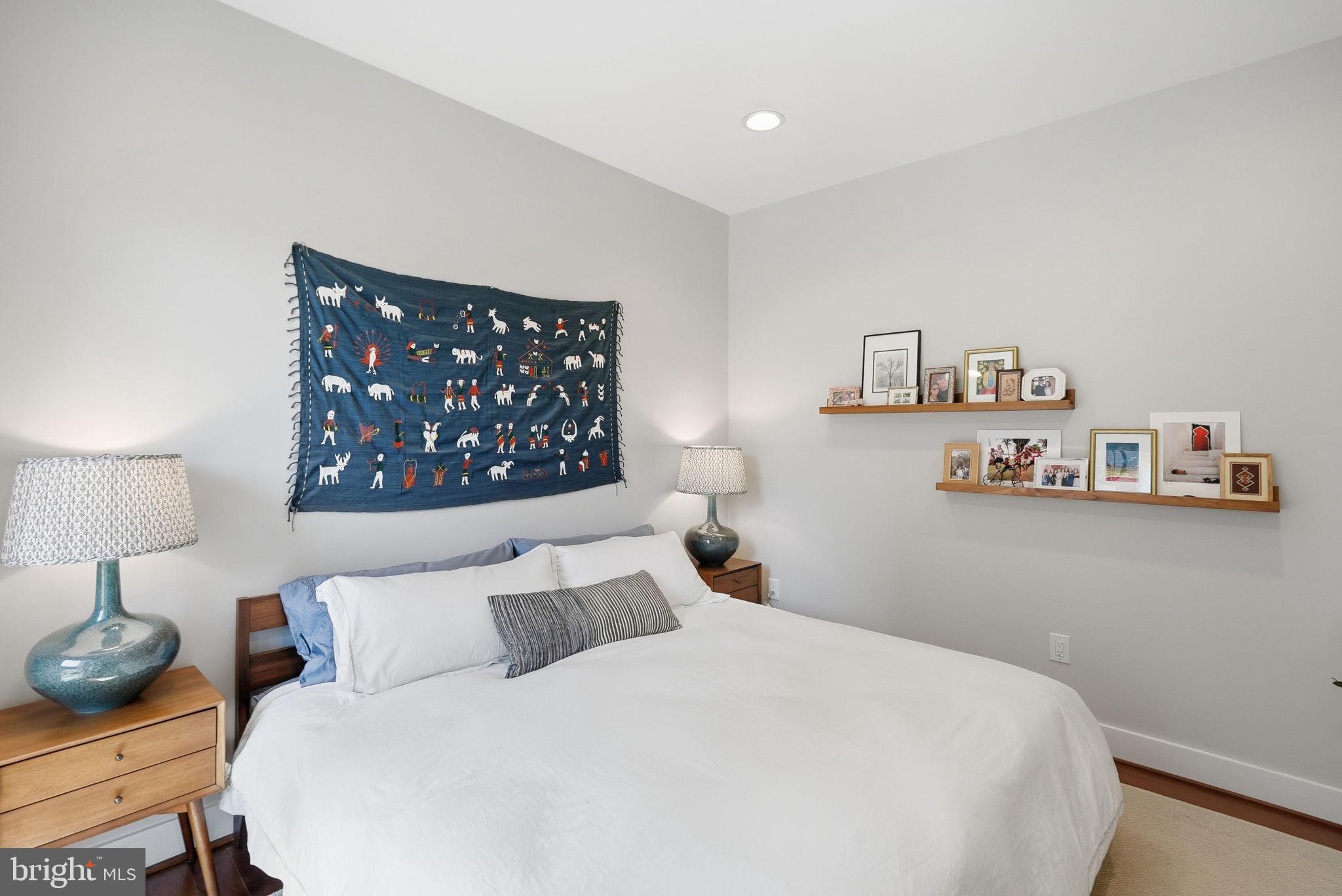1700 Euclid Street Northwest, Unit B3 Washington, DC 20009 - Photo 8 of 17 a bedroom with a bed and a wall painting