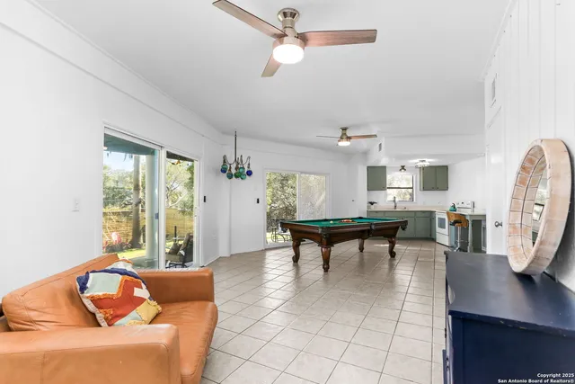 a living room with furniture a rug and a window